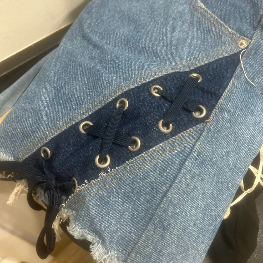 Denim Skirt with Lace-Up Detail fits like a medium